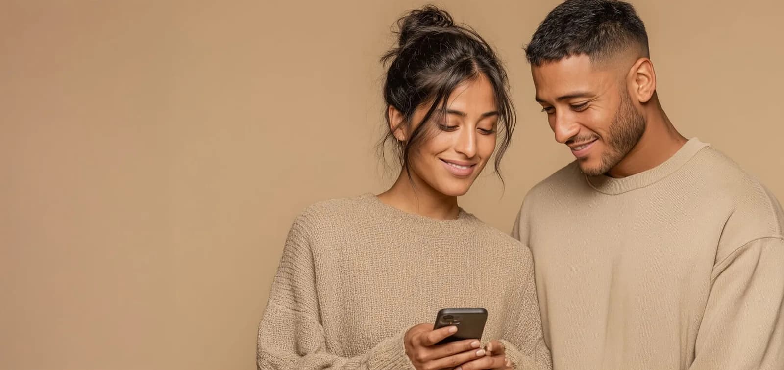 Couple opening a personalized wedding gift together in their already-furnished home, genuine moment of surprise and connection
