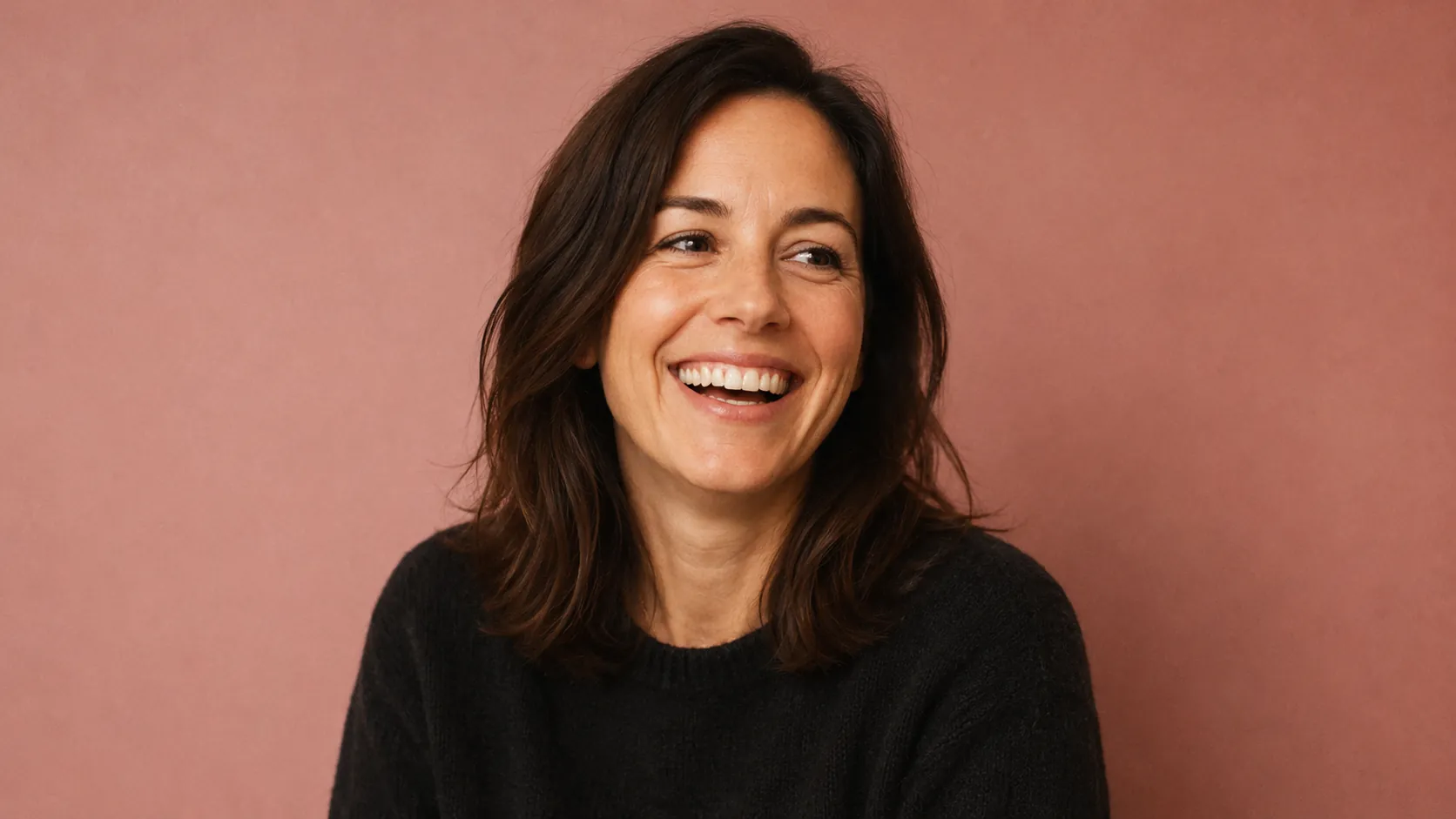 Portrait of Jennifer — 35-year-old American woman in soft black sweater, mid-laugh